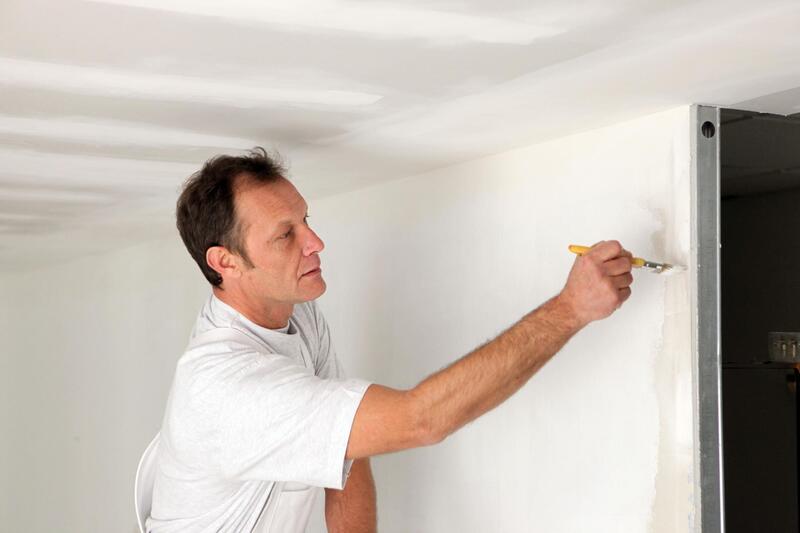 professional construction worker working on wall painting