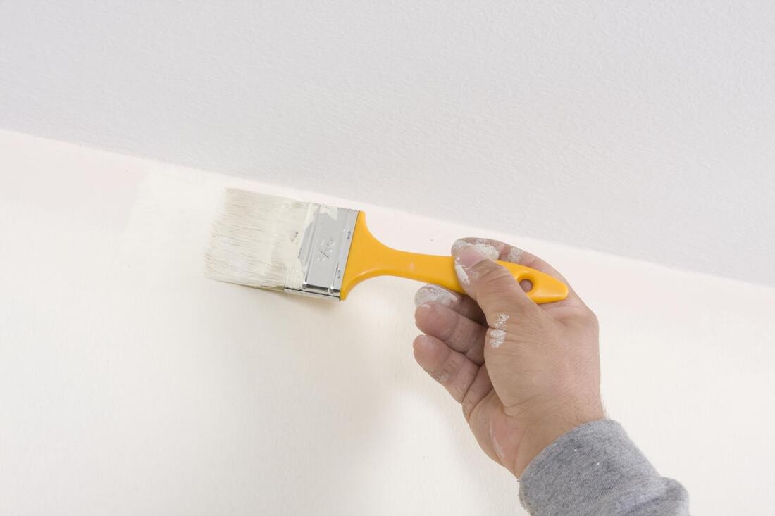 professional construction worker working on interior painting
